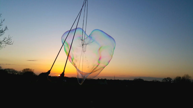 A Bubble in the shape of a heart with a sunset