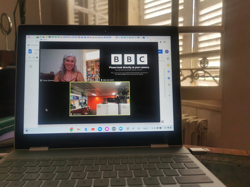 Dr Zigs interview with the BBC showing a laptop screen with a zoom call image with Paola Dyboski and the BBC logo
