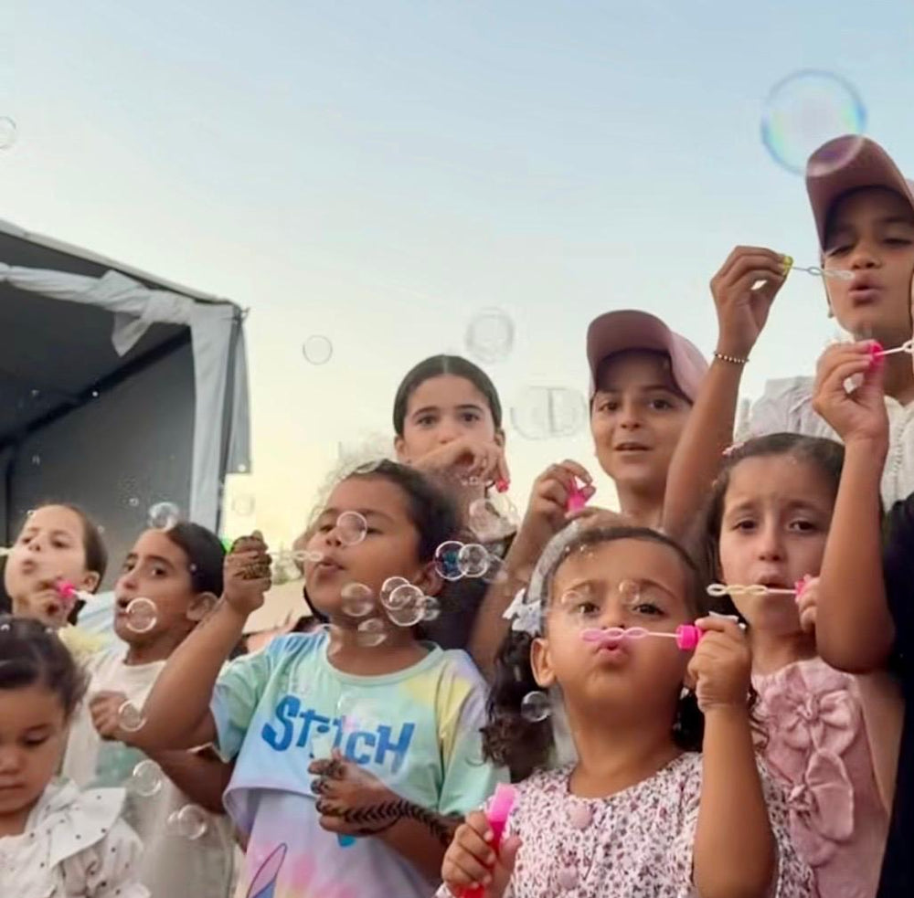 Children blowing bubbles together